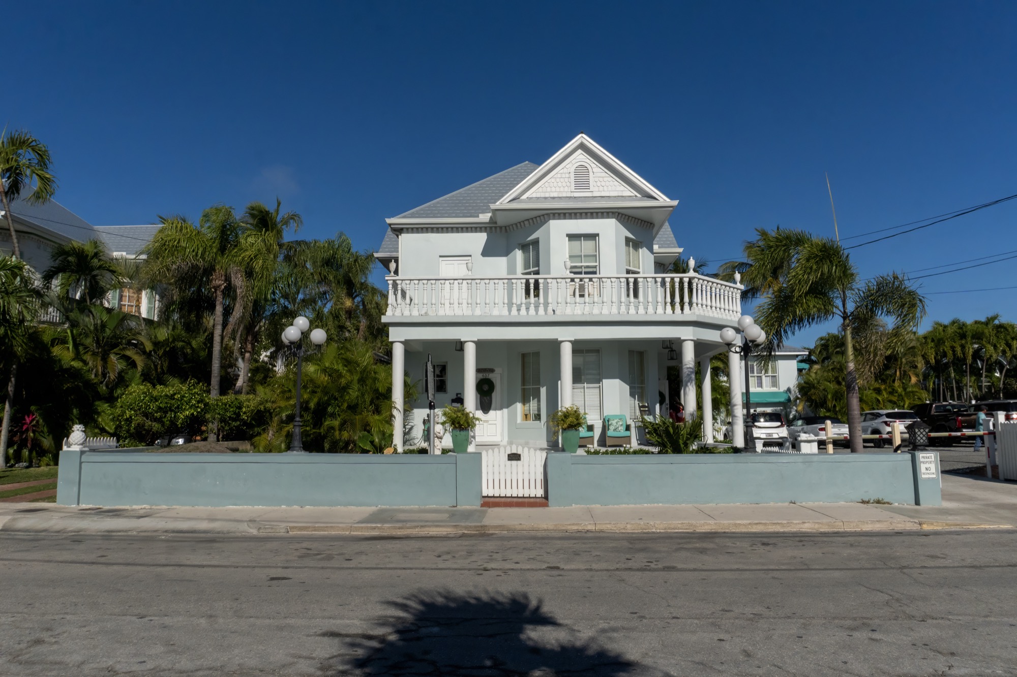 House with a front porch and palm trees in South Florida House with a front porch and palm trees in South Florida